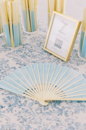 Blue fans for exterior summer wedding ceremony