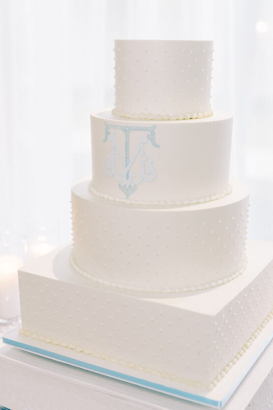 Mckenna and Tres all white wedding cake with blue monogram