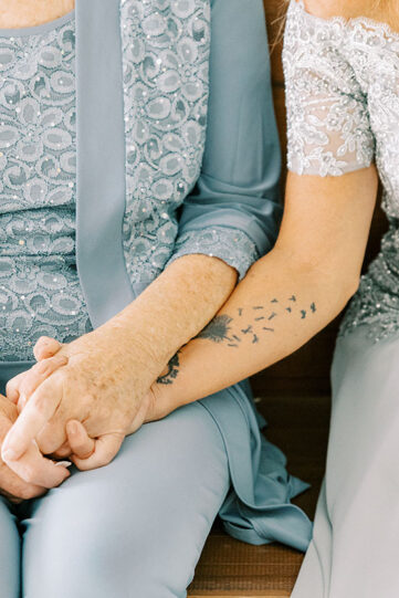 Family holding hands during wedding ceremony