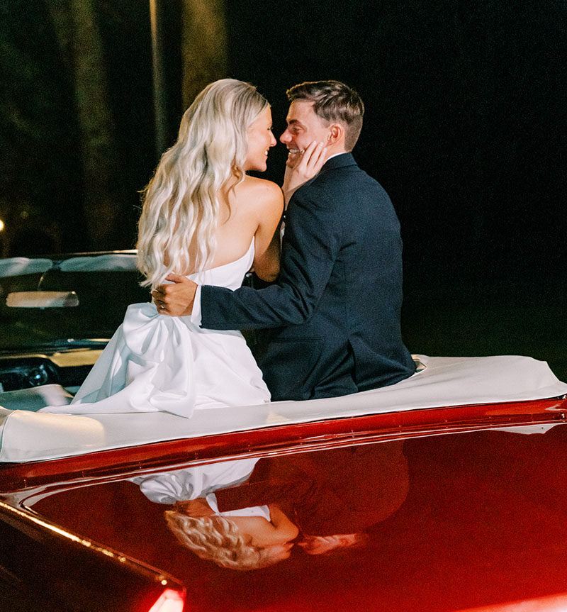 Mckenna and Tres wedding exit in vintage red car