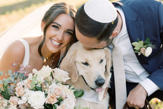 abby and jeff pose with their golden retriever