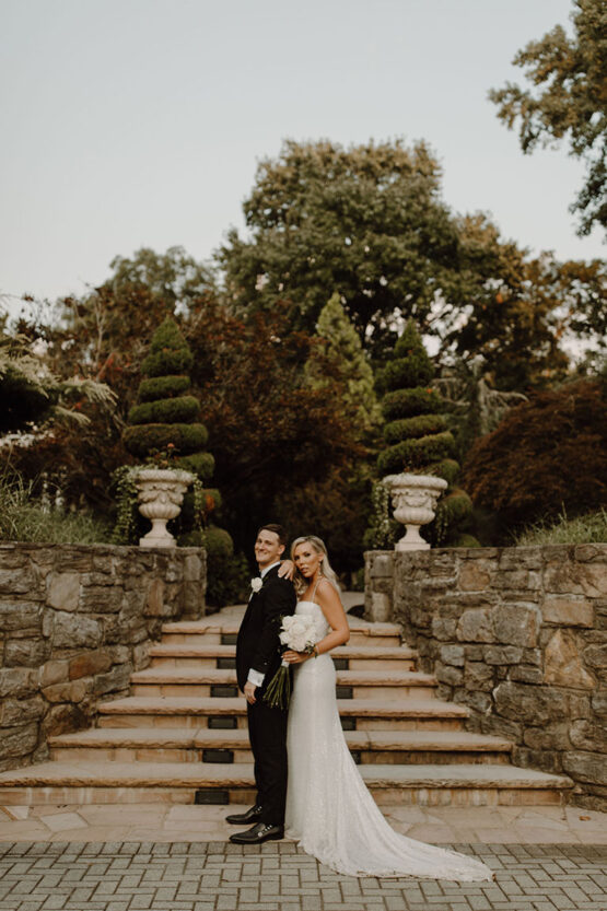 Bride and groom pose in front of Serenity Garden steps