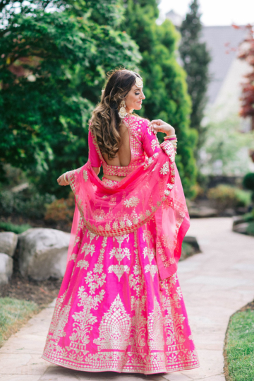 Bride posing in traditional Indian wedding clothes in Serenity Gardens