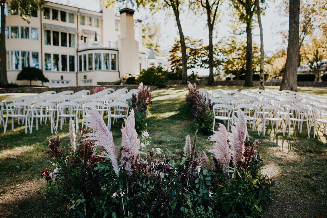 view from the end of the wedding aisle looking out toward the white seating before ceremony