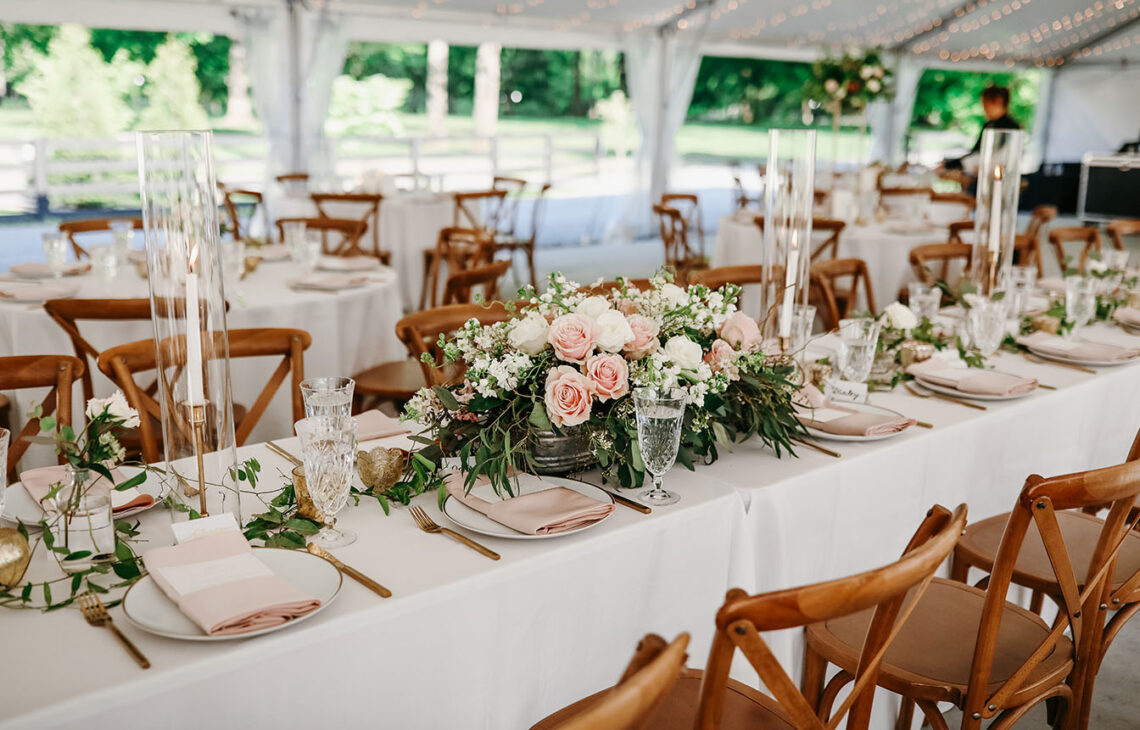 Kings table scape with ivory and light pink florals in the tented sunset terrace