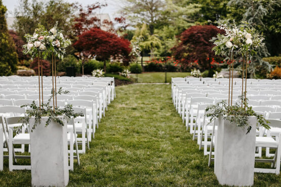 standing florals decorating the aisle of the ceremony in the Serenity Gardens