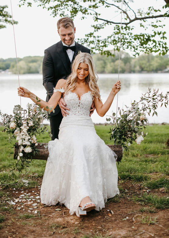 Brielle and Alec portrait on the floral decorated swing