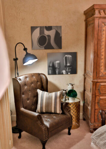 CDM Mansion_Garth-Bedroom_3 Brown leather chair with music artwork in Garth Brooks bedroom