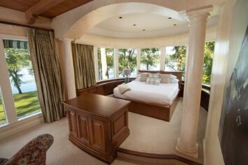 CDM Mansion_Reba-Suite_3_Micah-Beard King bed inside primary suite surrounded by windows