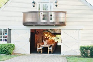 View from outside Carriage House Stables with rehearsal dinner table set inside