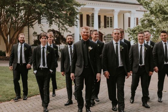 Tyler and Groomsmen Walking in Front of Mansion
