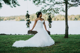 Danicia Sitting on Swing on Lakeside Lawn