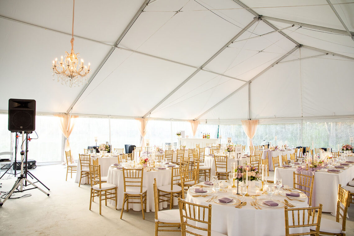 Bright and Airy Wedding Tablescape with Neutral White Linens Purple Napkins Gold Details and Bright Colorful Spring Floral Centerpieces