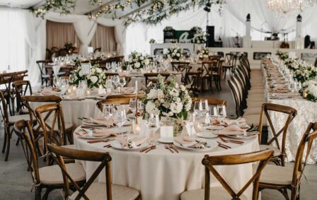 Wedding Reception setup on Sunset Terrace with greenery-covered ceiling and elegant white decor