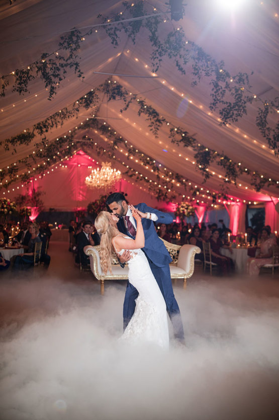 bride and groom during their first dance in their tented wedding reception