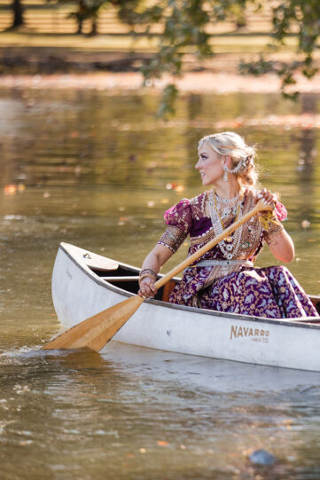 bride in the row boat at the estate at cherokee dock