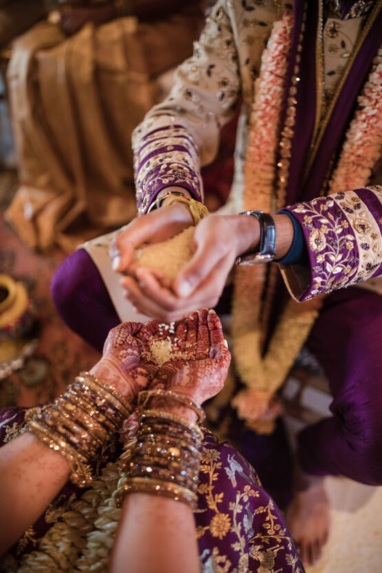 Henna hands pouring rice