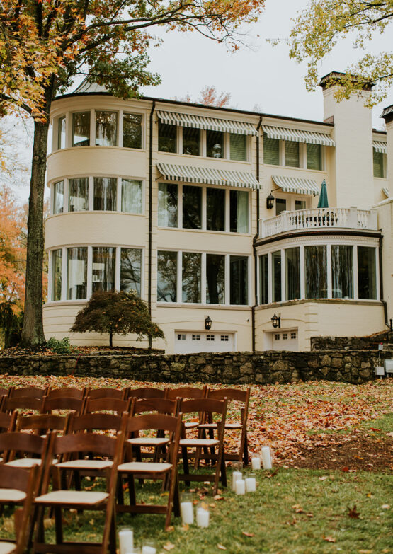 The mansion at the estate at cherokee dock during the fall with a ceremony set on the lakeside lawn