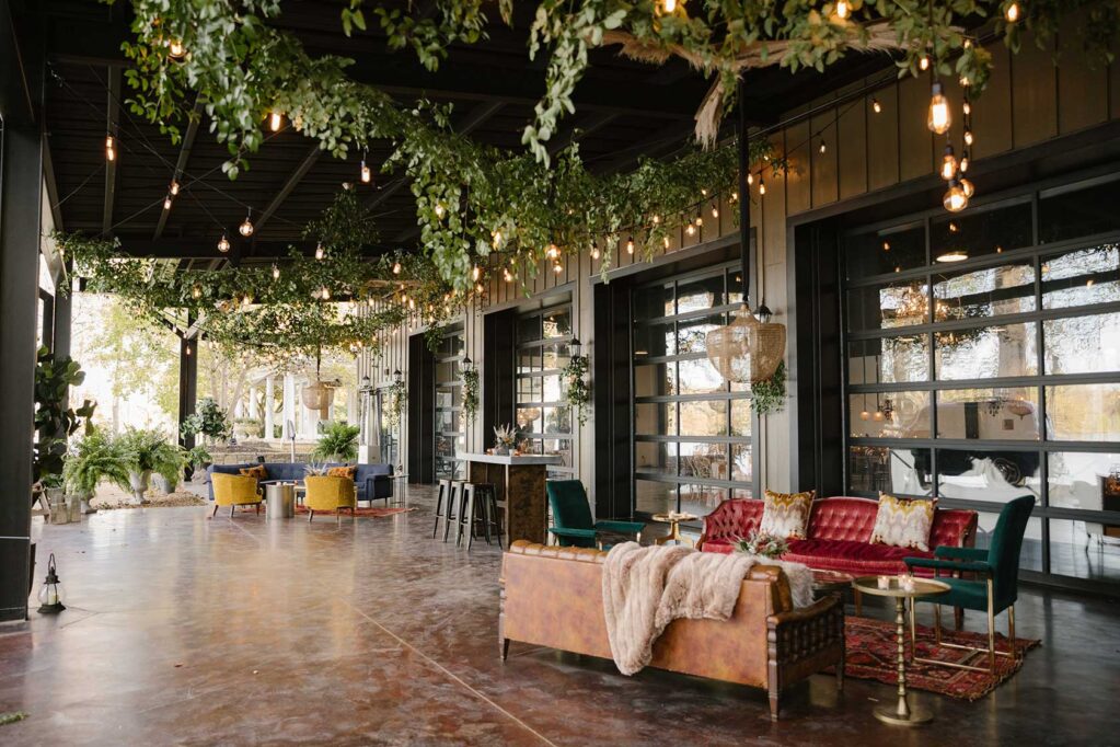 Vintage velvet furniture setup on the Lakeview Event Center patio with oriental rug and brass coffee table