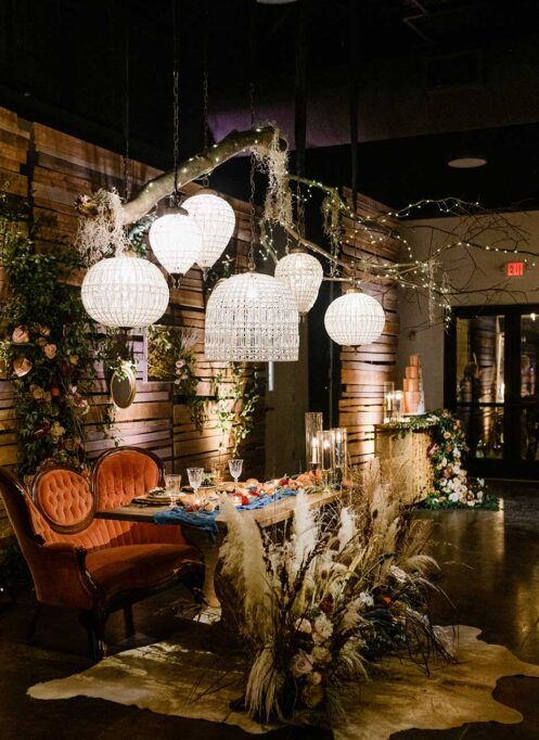 Vintage Boho Wedding Reception Sweetheart Table with bamboo lanterns and pampas grass arrangements