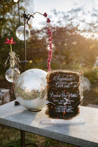 Signature Cocktail Bar Menu set on top of bar next to disco ball decor