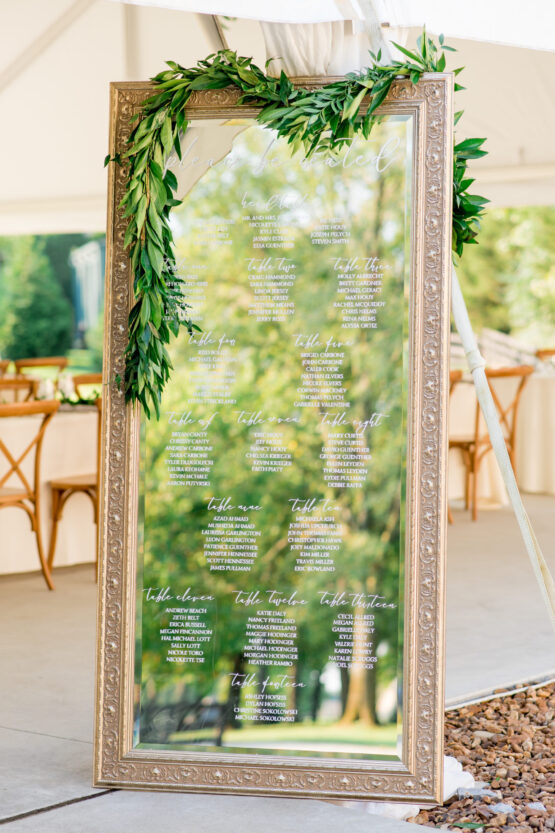 Wedding Reception Seating Chart Inspiration | Tall Gold Mirror with Handwritten Calligraphy and Greenery Decor| Tented Wedding Reception at The Estate at Cherokee Dock