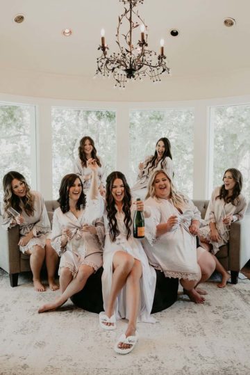 Hannah and her bridesmaids pop a bottle of champagne in preparation for the big day
