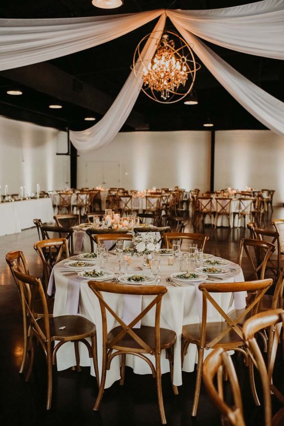 Reception during the daytime, white draping with white linens and lavender napkins.