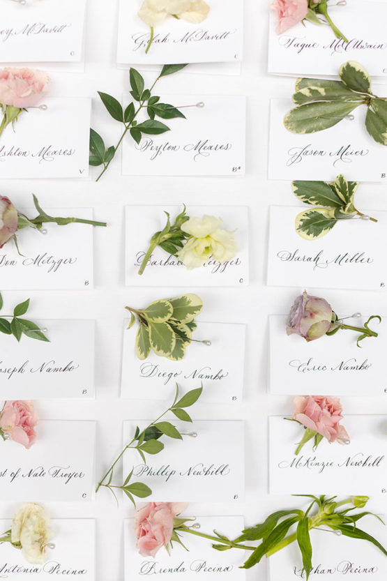 Escort Card Display Wall with Individual Flowers and Calligraphy for Bridgerton-Inspired Wedding at The Estate at Cherokee Dock