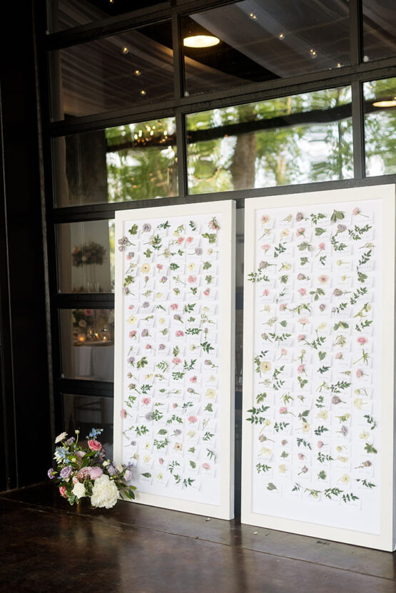 Personalized Floral Escort Name Place Card Display Wall with Individual Flowers and Calligraphy for Bridgerton-Inspired Wedding at The Estate at Cherokee Dock