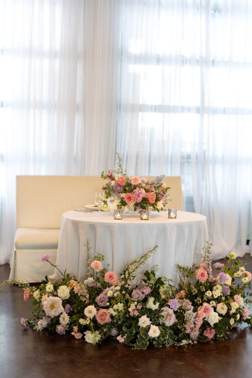 Unique and Charming Floral Sweetheart table with pastel florals