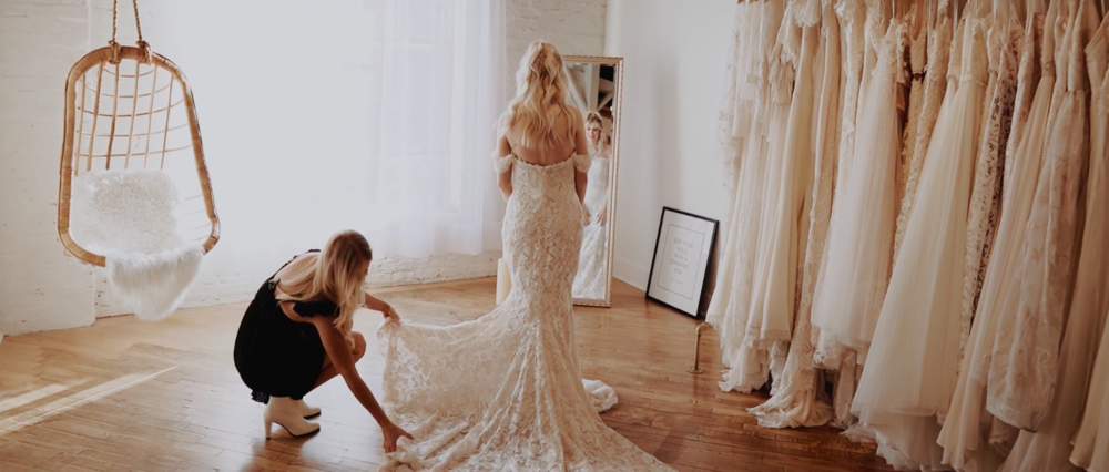 Bride trying on dress at Ila Bridal