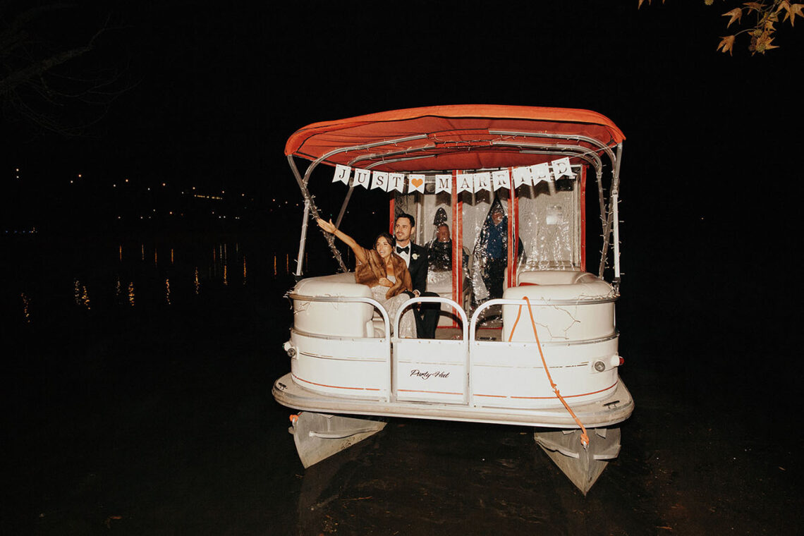 ben and jessica higgins wave goodbye on their pontoon boat exit