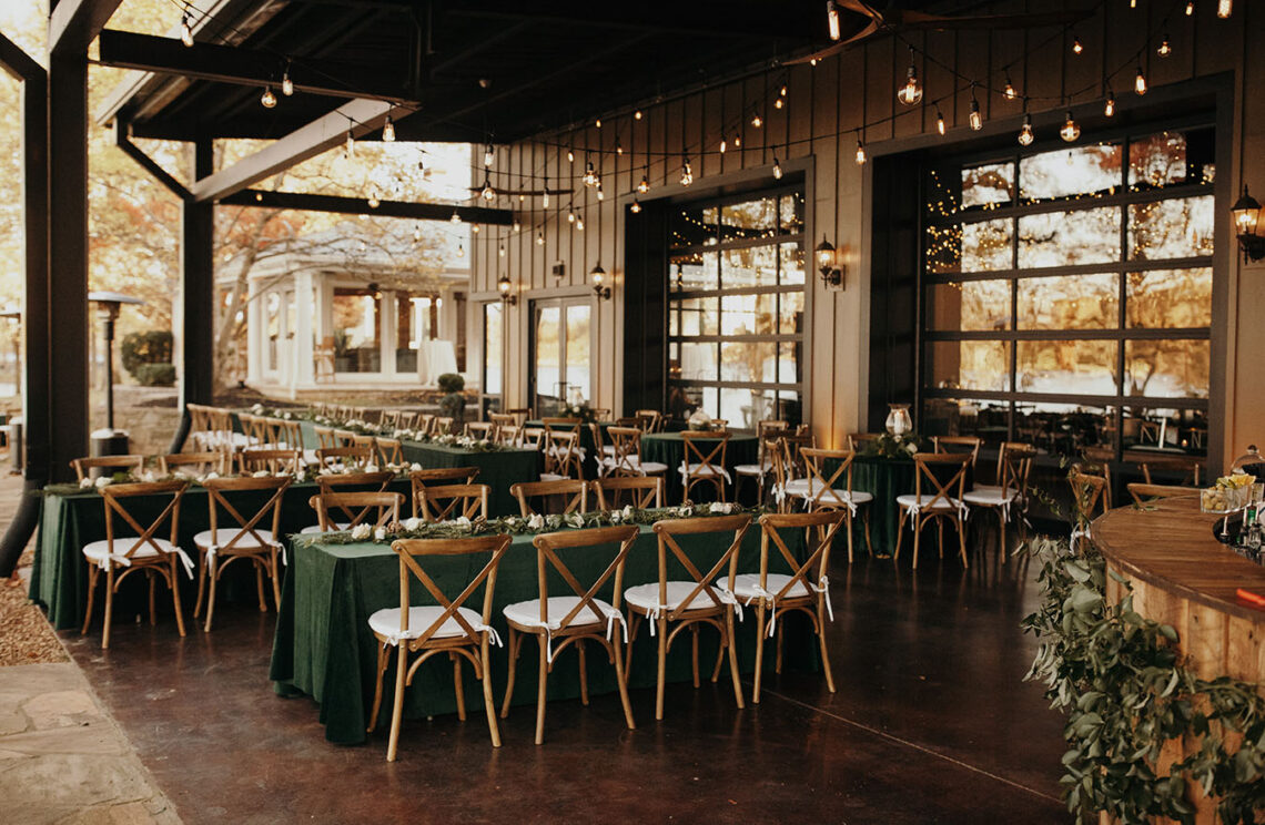 Wedding reception table setup on outdoor patio with string lights