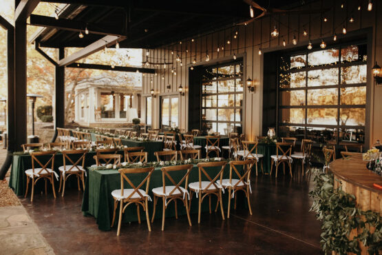 Wedding reception table setup on outdoor patio with string lights