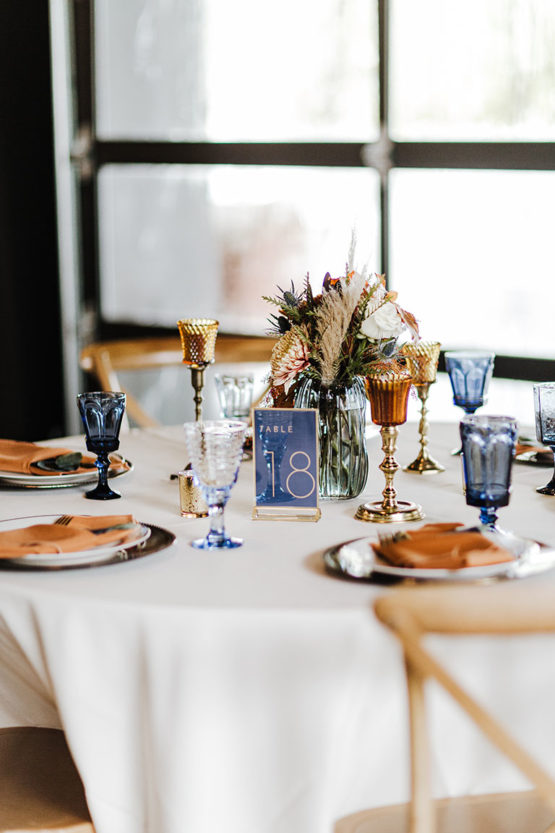 Wedding Reception Tablescape with Unique Blue Debutante Goblet Glassware, Dried Boho Centerpieces, Amber Glass Candle Holders |Fall Wedding Design Inspiration
