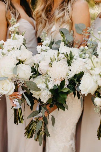 Classic white bridal bouquets with eucalyptus leaves wrapped in white ribbon