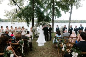 Father giving away his daughter at ceremony on Lakeside Lawn