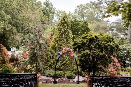 Black seating and ceremony arch set up in the serenity gardens