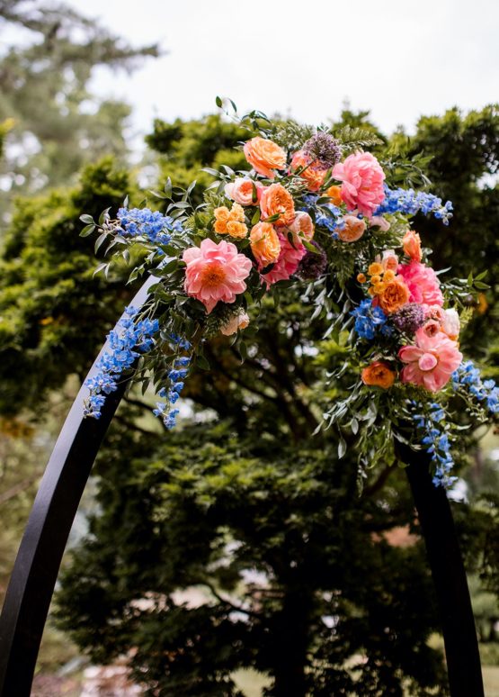 Black ceremony arch with florals