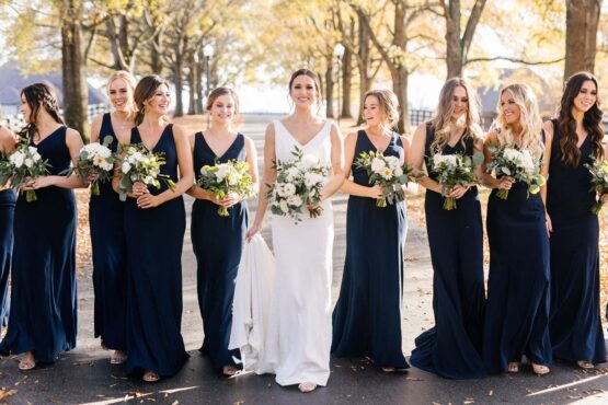 madison and her bridesmaids walking down the drive