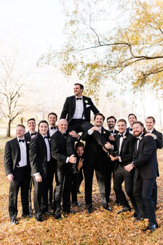 colton being held by his groomsmen