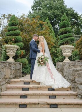 Bride and Groom on steps of Serenity Gardens