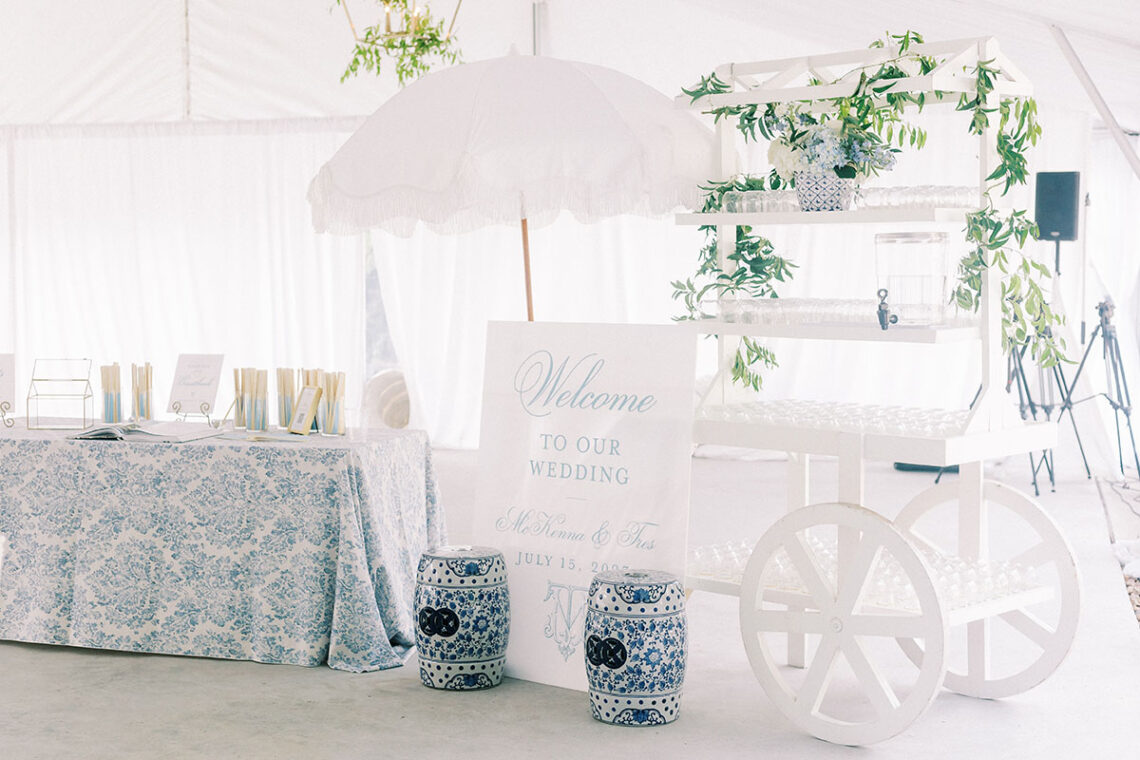 Welcome water station on white wagon for summer wedding