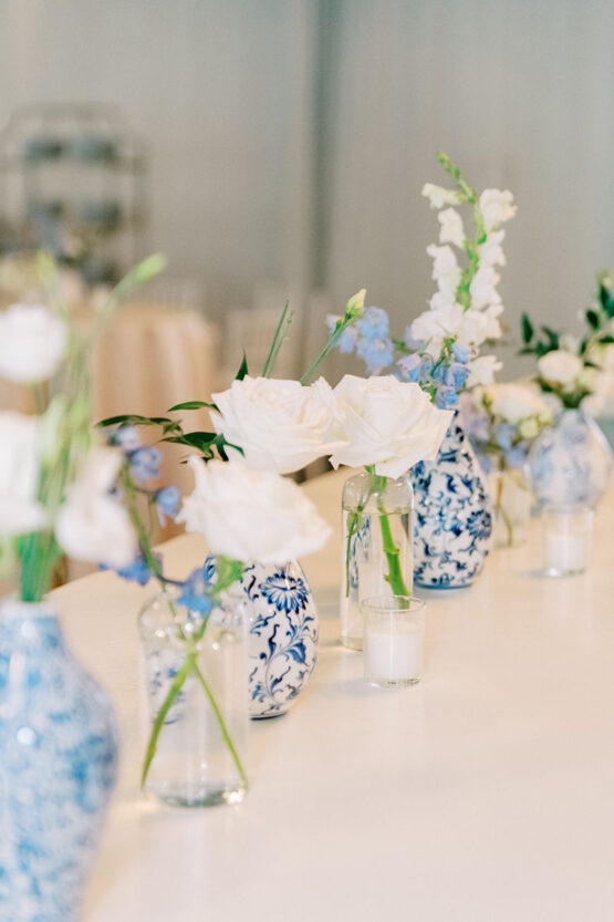 Closeup of individual bud vase centerpieces on reception table