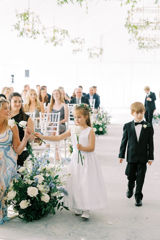Flower girl and ring bear walking down aisle during ceremony