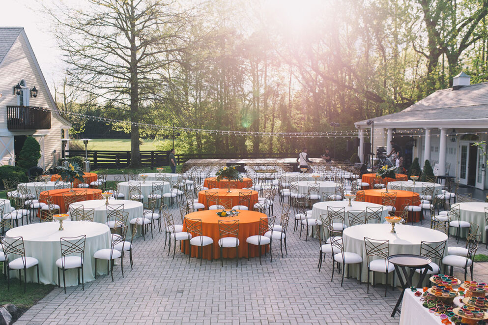 Wedding rehearsal dinner tables set up across Cobblestone Court