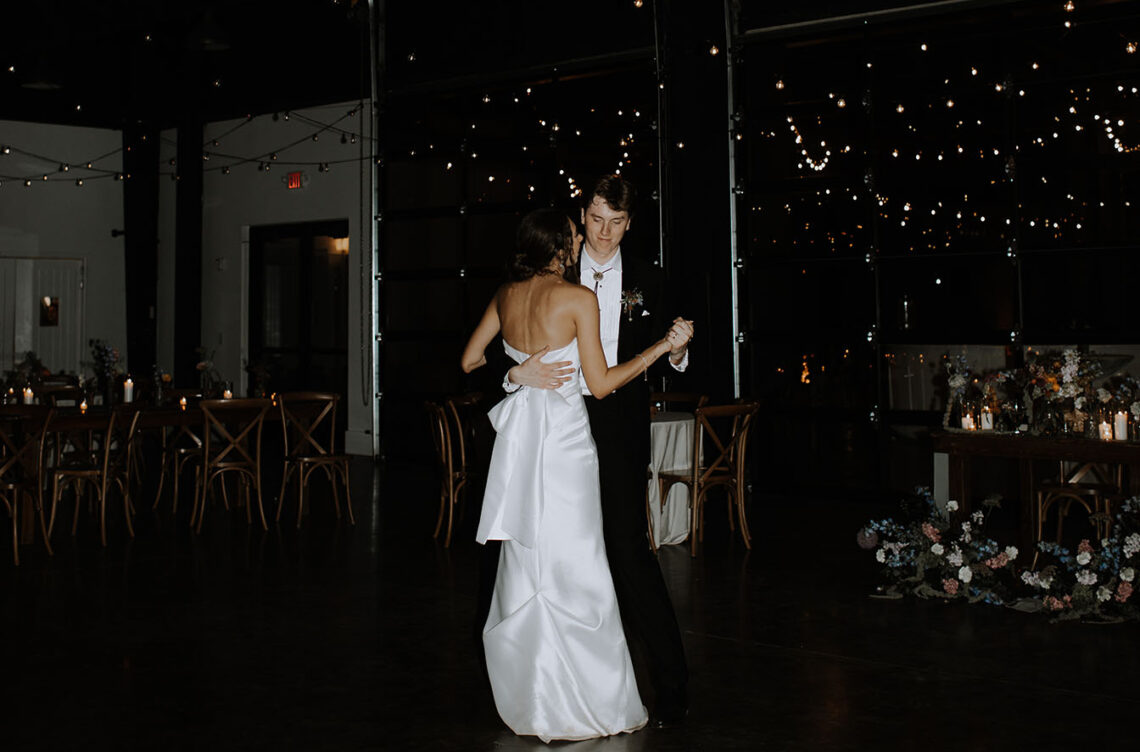 Bride and grime share private last dance in the event center underneath a disco ball