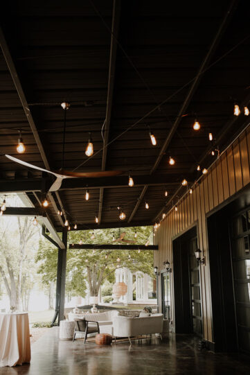 lakeview event center patio set with boho lounge seating and string lighting