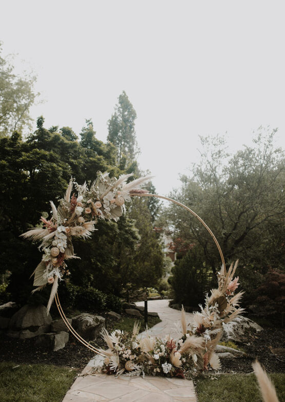 gold floral circle wedding ceremony with pampas